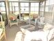 Bright sunroom with wicker furniture, lots of windows, and natural lighting at 537 Amberjack Dr, North Port, FL 34287