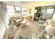 Bright sunroom with wicker furnishings and large sliding glass doors leading to the outside at 537 Amberjack Dr, North Port, FL 34287