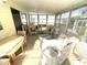 Inviting sunroom with wicker furnishings, large windows, and plenty of sunlight at 537 Amberjack Dr, North Port, FL 34287