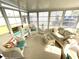 Well-lit sunroom featuring wicker furniture and many large windows, perfect for relaxation at 537 Amberjack Dr, North Port, FL 34287