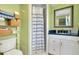 Charming bathroom featuring a tiled shower, decorative shelving, and blue accent pieces at 553 Circlewood Dr # T11, Venice, FL 34293