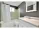 This bathroom features a tub and shower with tiled wall and white sink vanity at 553 Circlewood Dr # T11, Venice, FL 34293