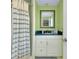 Bright bathroom featuring a shower, mirror, and white vanity with blue accents at 553 Circlewood Dr # T11, Venice, FL 34293