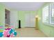 Bright bedroom features tiled flooring, white sliding closet doors and a sun-filled window with shutter blinds at 553 Circlewood Dr # T11, Venice, FL 34293