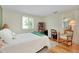 Bright bedroom with hardwood floors, natural light, and a chair near the window at 553 Circlewood Dr # T11, Venice, FL 34293