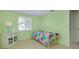 Bright bedroom featuring tile flooring, white furniture, window with shutters, and colorful floral quilt at 553 Circlewood Dr # T11, Venice, FL 34293