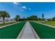 Bocce ball court surrounded by manicured landscaping, benches and trees at 553 Circlewood Dr # T11, Venice, FL 34293