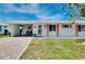 Charming home featuring a well-manicured lawn, attractive shutters, and a welcoming front entrance at 553 Circlewood Dr # T11, Venice, FL 34293