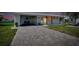Well-maintained home featuring an attractive brick driveway, carport, and pristine landscaping at 553 Circlewood Dr # T11, Venice, FL 34293