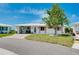 Charming home with a paved driveway, carport, and lush lawn, radiating curb appeal at 553 Circlewood Dr # T11, Venice, FL 34293