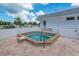 Community hot tub surrounded by a privacy fence, with lounge chairs available for relaxation at 553 Circlewood Dr # T11, Venice, FL 34293