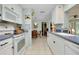 Well-lit kitchen offers ample cabinet space, view to dining area, and modern appliances at 553 Circlewood Dr # T11, Venice, FL 34293