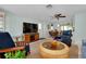 Relaxing living room showcasing a wicker coffee table, TV, and views to a dining area at 553 Circlewood Dr # T11, Venice, FL 34293