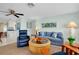 Relaxing living room with comfortable seating, ceiling fan, and colorful artwork creating a welcoming atmosphere at 553 Circlewood Dr # T11, Venice, FL 34293