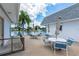 Charming outdoor patio overlooking a serene lake, furnished with tables and chairs for relaxing and enjoying the scenic view at 553 Circlewood Dr # T11, Venice, FL 34293