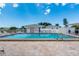 Community pool with plenty of lounge chairs and shaded areas for relaxation at 553 Circlewood Dr # T11, Venice, FL 34293