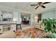 Open sunroom with comfortable seating, tile flooring, and a view into the dining area and kitchen at 553 Circlewood Dr # T11, Venice, FL 34293