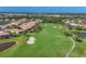 Expansive aerial view of a green golf course, complete with sand traps and a walking path at 5641 Hidden Oak Ct, North Port, FL 34287