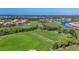 Beautiful aerial view of a golf course community featuring lush green fairways and blue ponds at 5641 Hidden Oak Ct, North Port, FL 34287