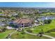Wide aerial of community featuring golf course, lakes and manicured landscaping at 5641 Hidden Oak Ct, North Port, FL 34287
