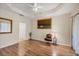 Spacious bedroom with tray ceilings, hardwood floors, and neutral decor, perfect for relaxation at 5641 Hidden Oak Ct, North Port, FL 34287