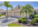 Charming home featuring a three-car garage, tile roof, and well-manicured landscaping with mature palms at 5641 Hidden Oak Ct, North Port, FL 34287