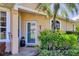 Inviting front entrance with decorative plants and charming outdoor lighting at 5641 Hidden Oak Ct, North Port, FL 34287