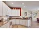 Open kitchen with modern appliances and seamless transition to the dining and living areas at 5641 Hidden Oak Ct, North Port, FL 34287