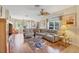 Bright living room boasting wood floors, large windows, and a cozy seating area at 5641 Hidden Oak Ct, North Port, FL 34287