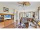Inviting living space featuring wood floors, neutral walls, and a ceiling fan at 5641 Hidden Oak Ct, North Port, FL 34287