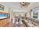 Spacious living area with wood floors, natural light, and comfortable furnishings at 5641 Hidden Oak Ct, North Port, FL 34287