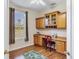Charming office features laminate floor, built-in desk and cabinets, with exterior view at 5641 Hidden Oak Ct, North Port, FL 34287