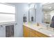 Bathroom featuring a double sink vanity with quartz countertop, modern lighting, and dual mirrors at 608 Apalachicola Rd, Venice, FL 34285