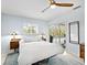 Light and bright bedroom features backyard pool views, and is illuminated with two table lamps at 608 Apalachicola Rd, Venice, FL 34285