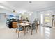 Open floor plan featuring a dining area and a living room with a flat-screen TV and stylish decor at 608 Apalachicola Rd, Venice, FL 34285