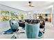 Bright living room with modern furnishings and a large window overlooking the landscaped front yard at 608 Apalachicola Rd, Venice, FL 34285