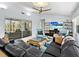 Inviting living room featuring stylish furnishings, entertainment center, and sliding doors at 608 Apalachicola Rd, Venice, FL 34285
