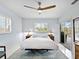 Bedroom with a bed, ceiling fan, plantation shutters, and sliding glass doors to the outside at 608 Apalachicola Rd, Venice, FL 34285