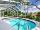 Screened-in pool with clear blue water and ample space for seating at 608 Apalachicola Rd, Venice, FL 34285