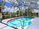 Refreshing pool with screened enclosure and lush landscaping views at 608 Apalachicola Rd, Venice, FL 34285