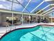 Beautiful pool with screened-in lanai and comfortable outdoor seating at 608 Apalachicola Rd, Venice, FL 34285