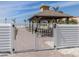 Beach access with gated entrance and covered gazebo, providing a scenic view at 616 Gardenia Dr, Venice, FL 34285