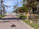 Scenic beach access pathway with brick pavers and mature palm trees at 616 Gardenia Dr, Venice, FL 34285