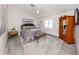 Bright bedroom with hardwood floors, large bed, and natural lighting at 616 Gardenia Dr, Venice, FL 34285