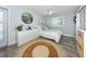 Cozy bedroom features a comfortable bed, soft blue walls, and a decorative rug, creating a relaxing and inviting atmosphere at 616 Gardenia Dr, Venice, FL 34285