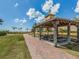Charming covered picnic area with tables, benches, and a view of the beach at 616 Gardenia Dr, Venice, FL 34285