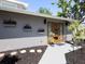 Inviting front entrance featuring a modern wooden door and charming flower boxes at 616 Gardenia Dr, Venice, FL 34285