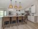 Modern kitchen island featuring woven stools and white cabinetry at 616 Gardenia Dr, Venice, FL 34285