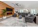 Comfortable living room boasts a wood accent wall and a plush gray sectional at 616 Gardenia Dr, Venice, FL 34285