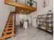 Spacious living room with dining area, light hardwood floors, floating staircase, and contemporary decor at 616 Gardenia Dr, Venice, FL 34285